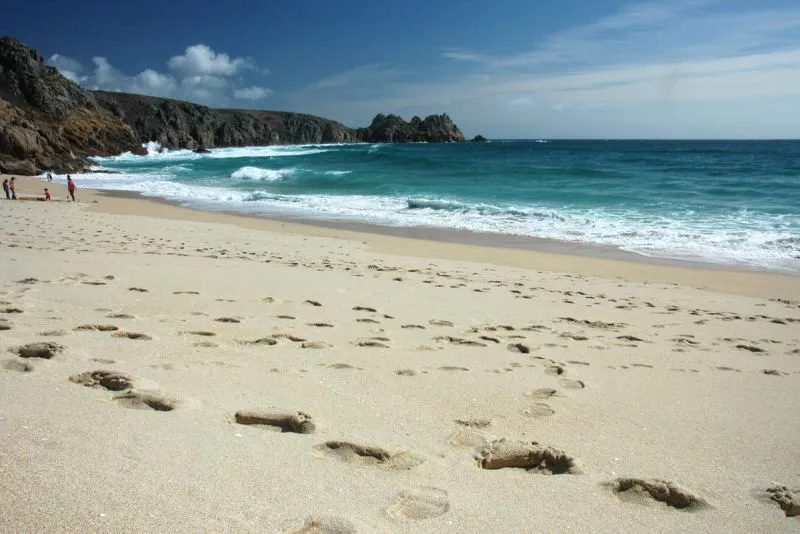 /public/photos/Porthcurno Beach - family and footprints in the sand